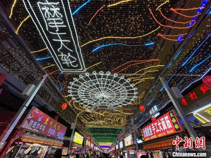 圖為明清街夜市燈光點(diǎn)亮具有武威文化元素的“摩天輪”彩燈?！〈魑牟?攝</p><p>